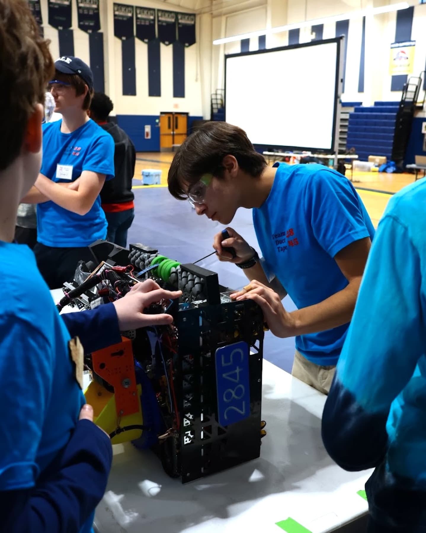 Samuel Anes working on FTC Team 2845 robot in the pits
