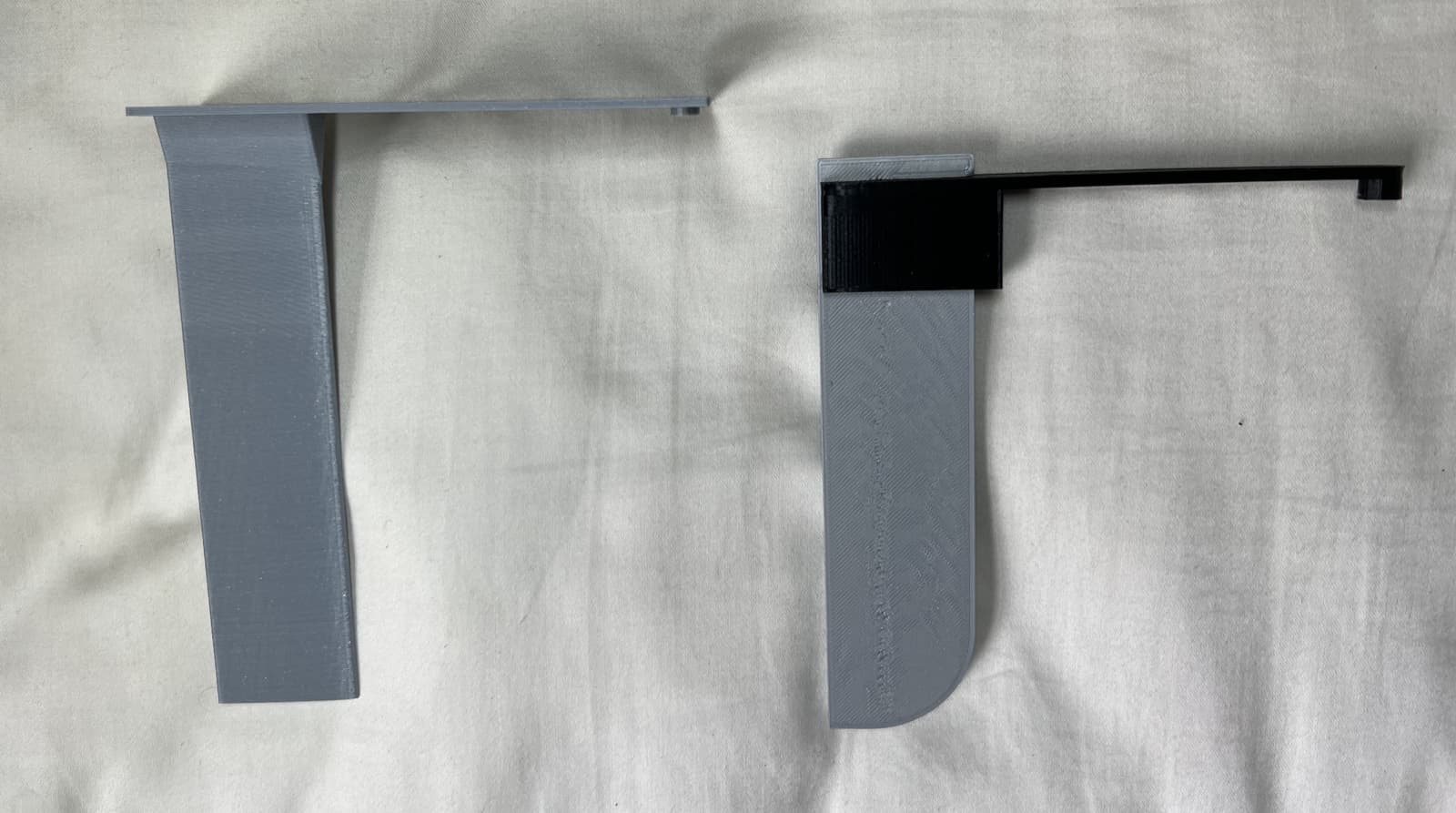 Two versions of the 3D-printed rudder side by side